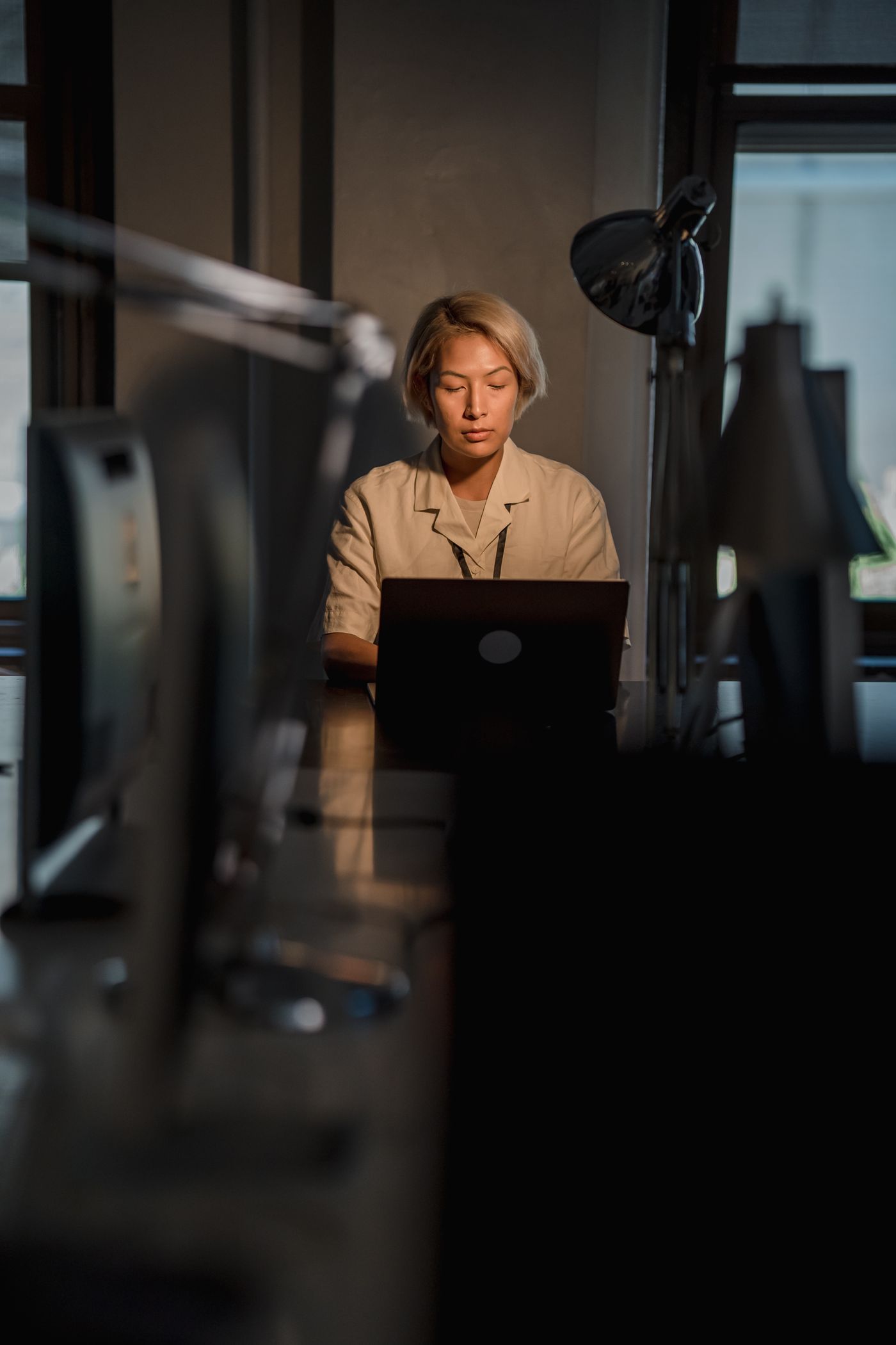 Someone working late at a laptop in a quiet office